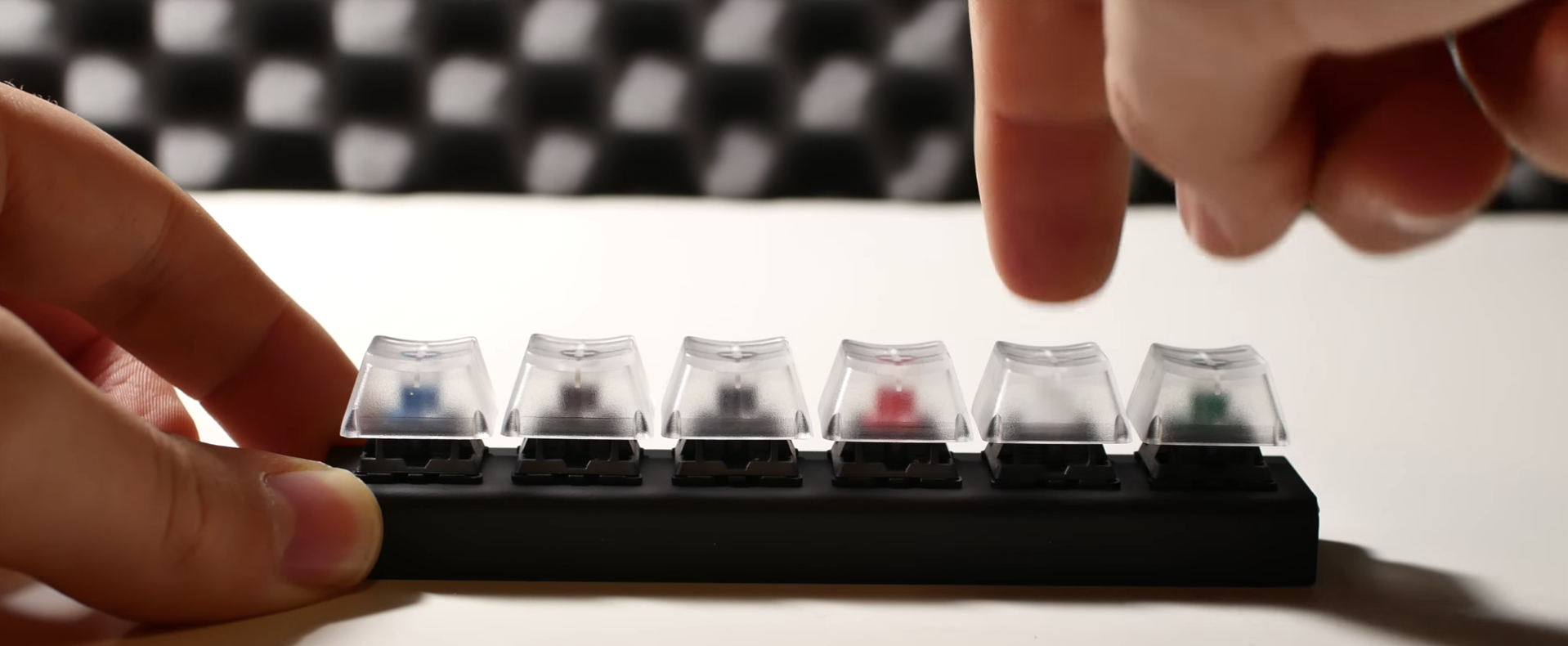 A set of blue, brown, black, red, white and green mechanical keyboard switches.